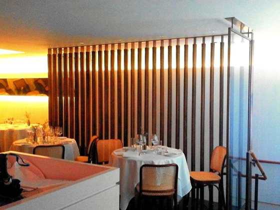 Brass rail and glass screen in a dining room