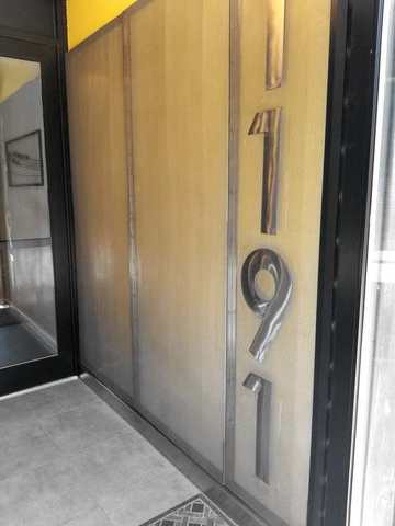 Entry door with cut metal numbers