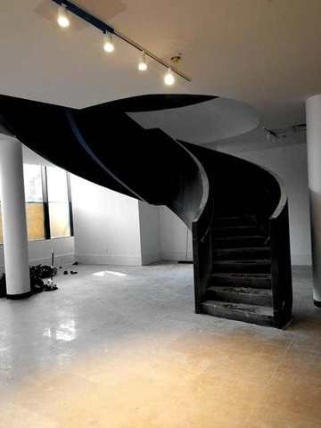 Helical steel stair in a finished room