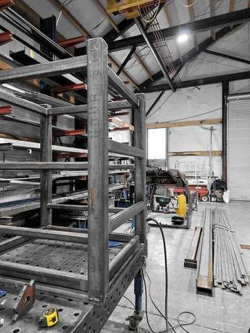 A tall welded frame standing in the shop