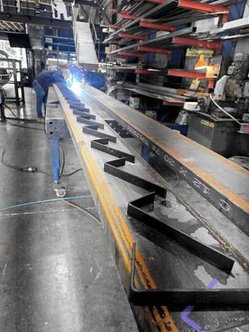 Welding a long sawtooth stringer down the length of the shop
