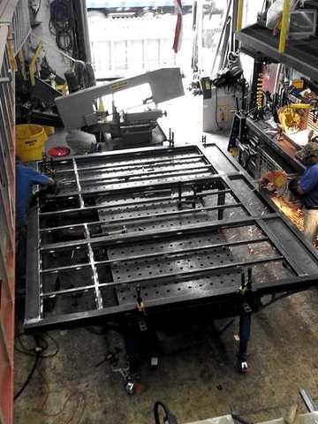 Steel frames laid out on a fixture table
