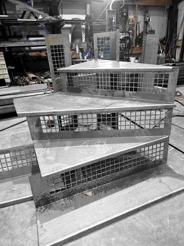 Winder pans with mesh risers, stacked for a fit check